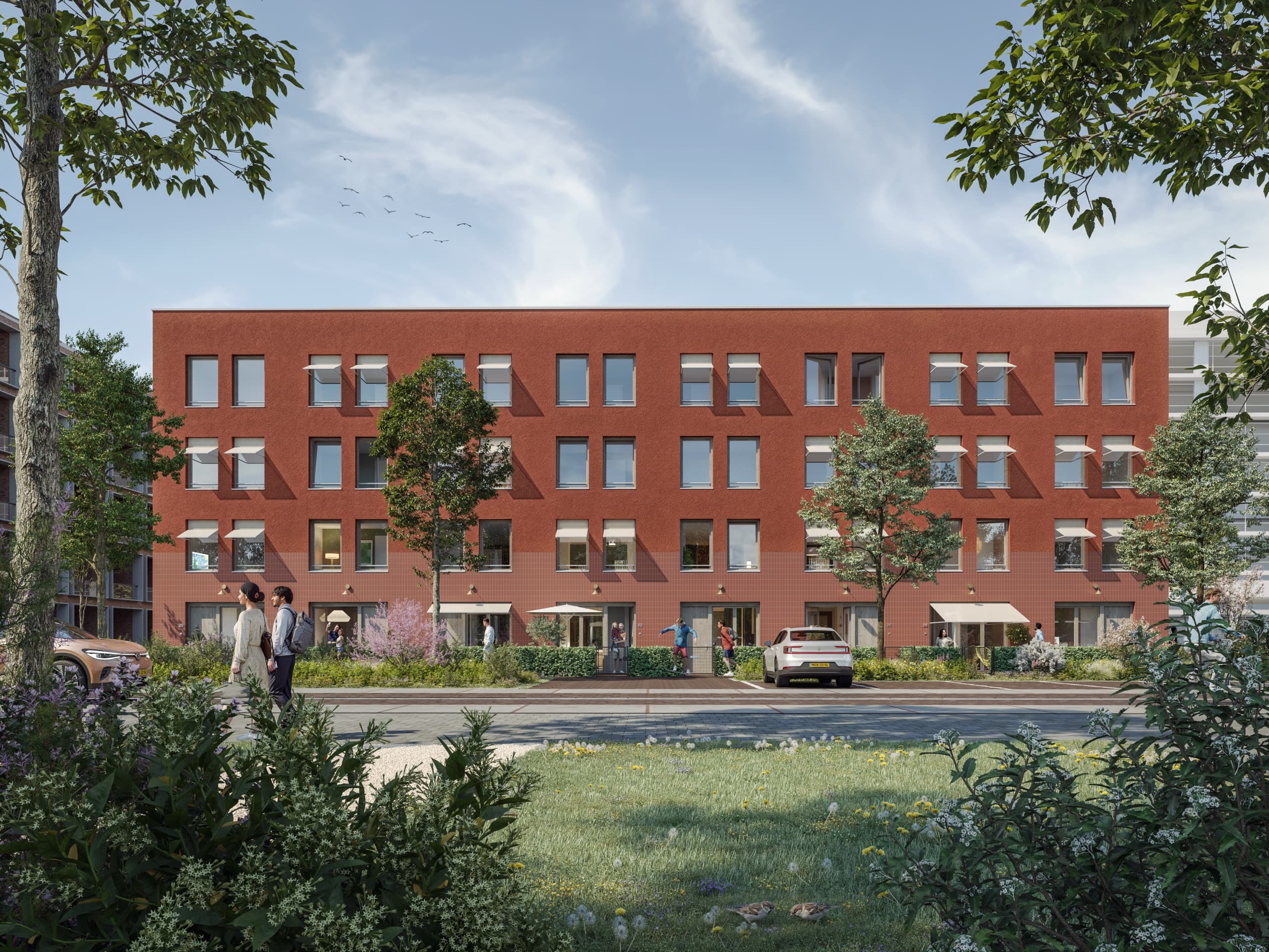 Impressie van Blend: de rode bakstenen gevel van de stadswoningen aan de straat, vanuit het groen